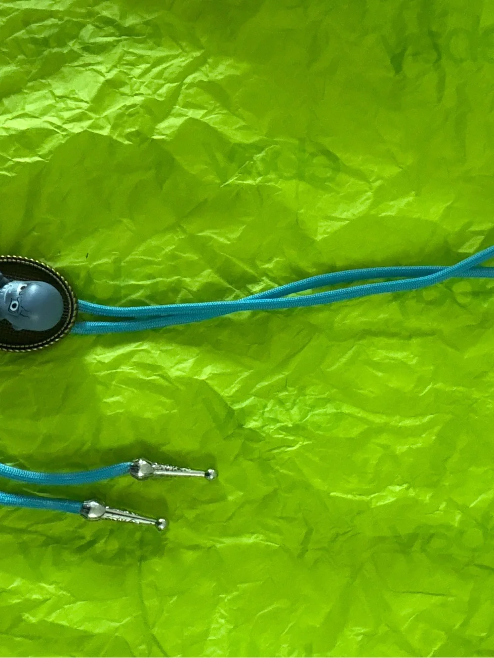 Blue Vinyl Character Figure with Gold Accent Bolo Tie